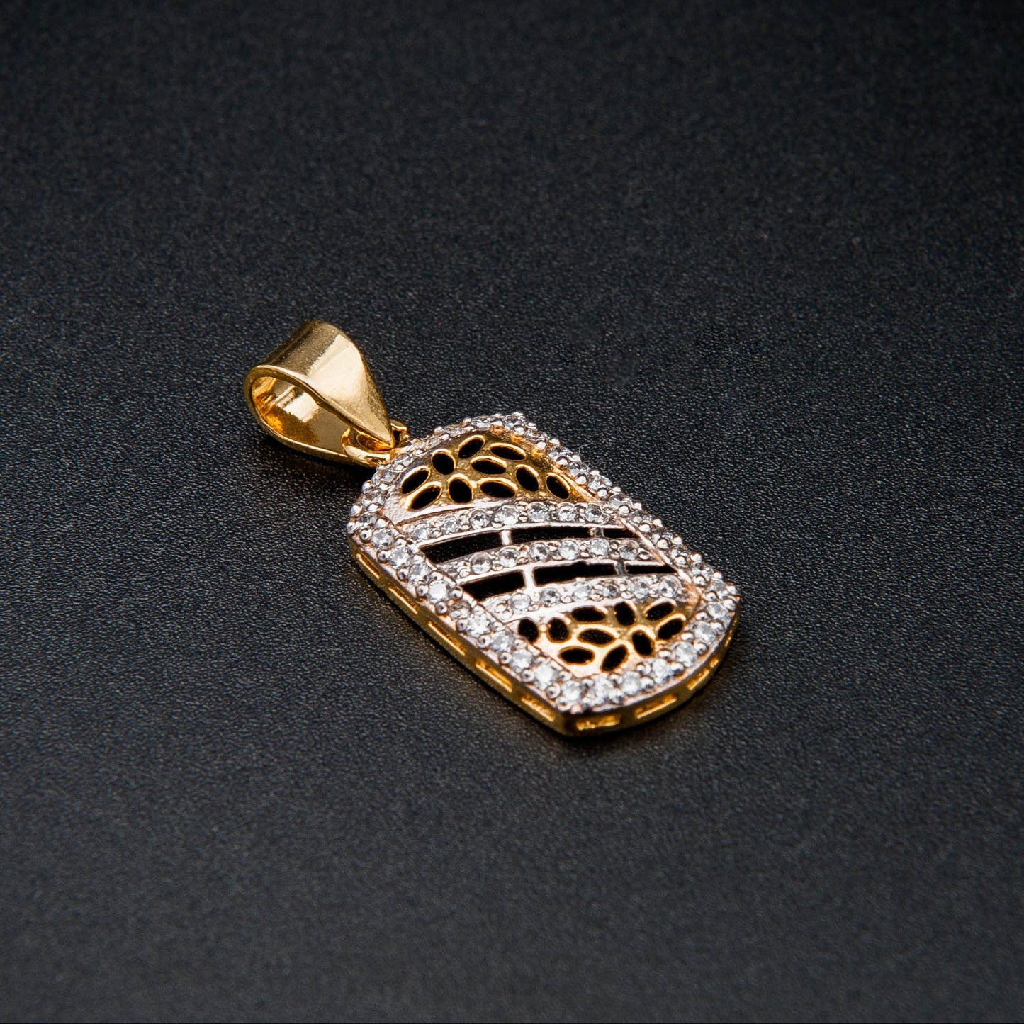 Gold pendant on a black background