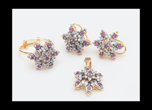 Set of gold jewelry with star-shaped designs and gemstones on a white background