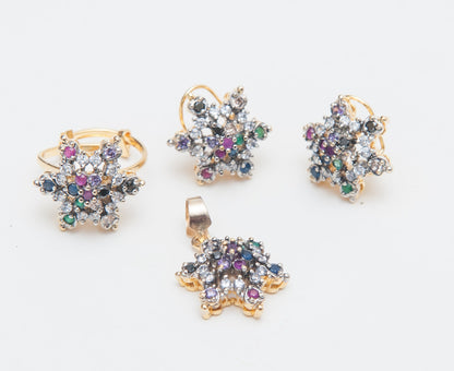 Set of gold jewelry with multicolored gemstones on a white background