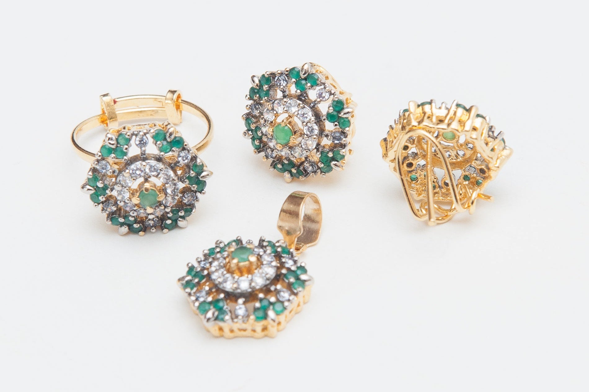 Gold and gemstone jewelry set on a white background