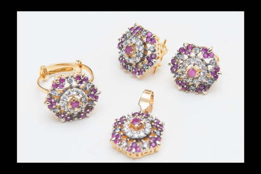 Jewelry set with gold earrings and pendant featuring purple and clear gemstones on a white background