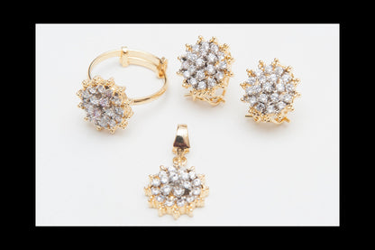 Gold jewelry set with floral designs on a white background