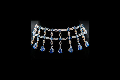 Silver necklace with blue gemstones on a black background