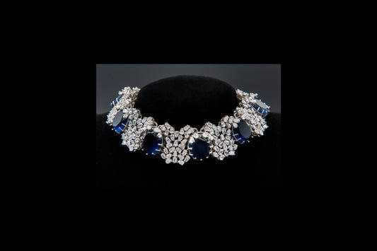 Diamond and sapphire bracelet on a black stand