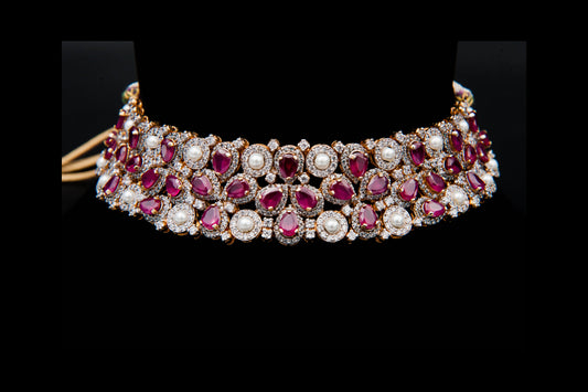 Jewelry necklace with red stones and pearls on a black background