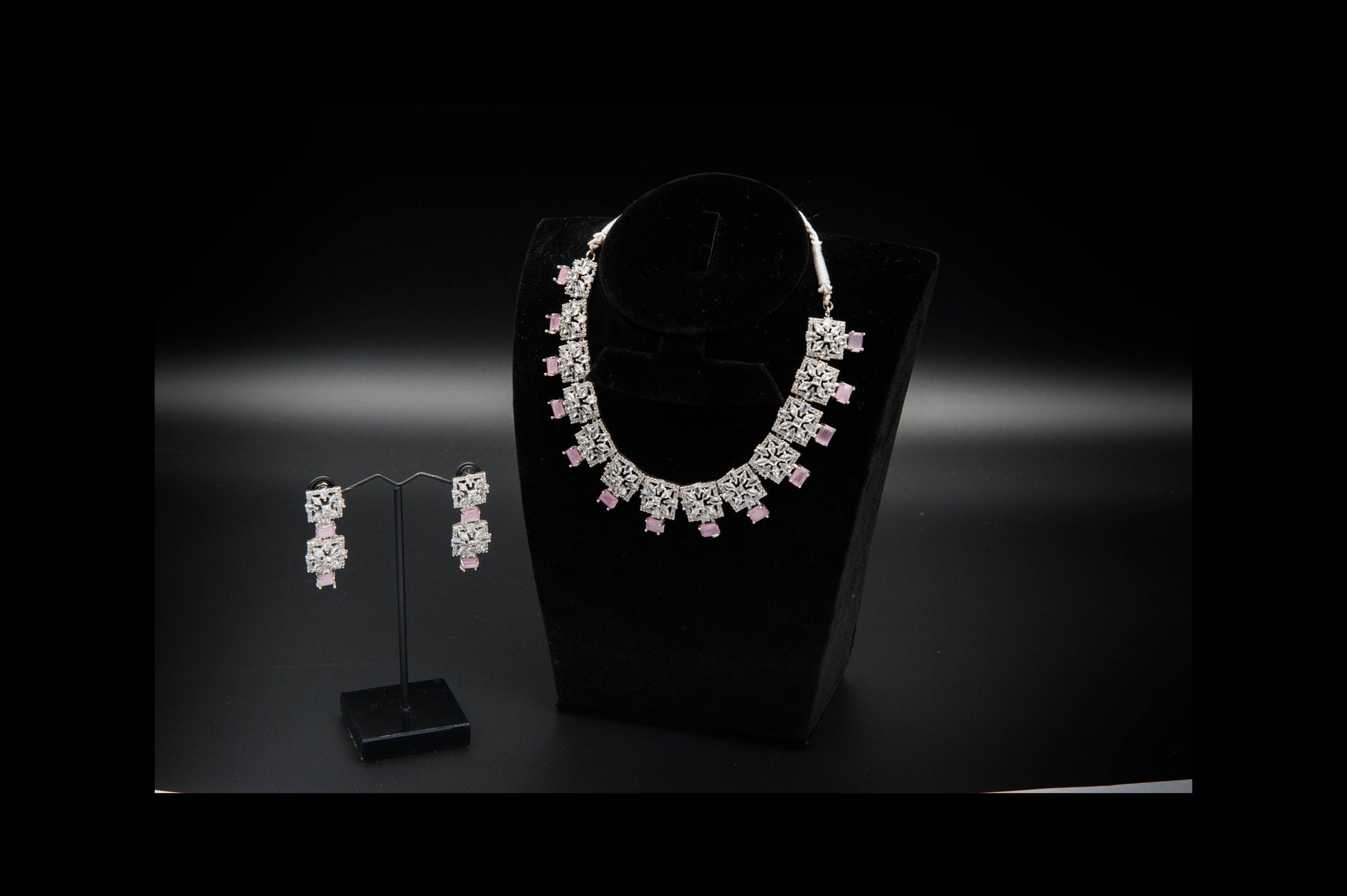 Jewelry set with necklace and earrings on a black background