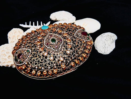 Decorative belt buckle with gemstones on a black background